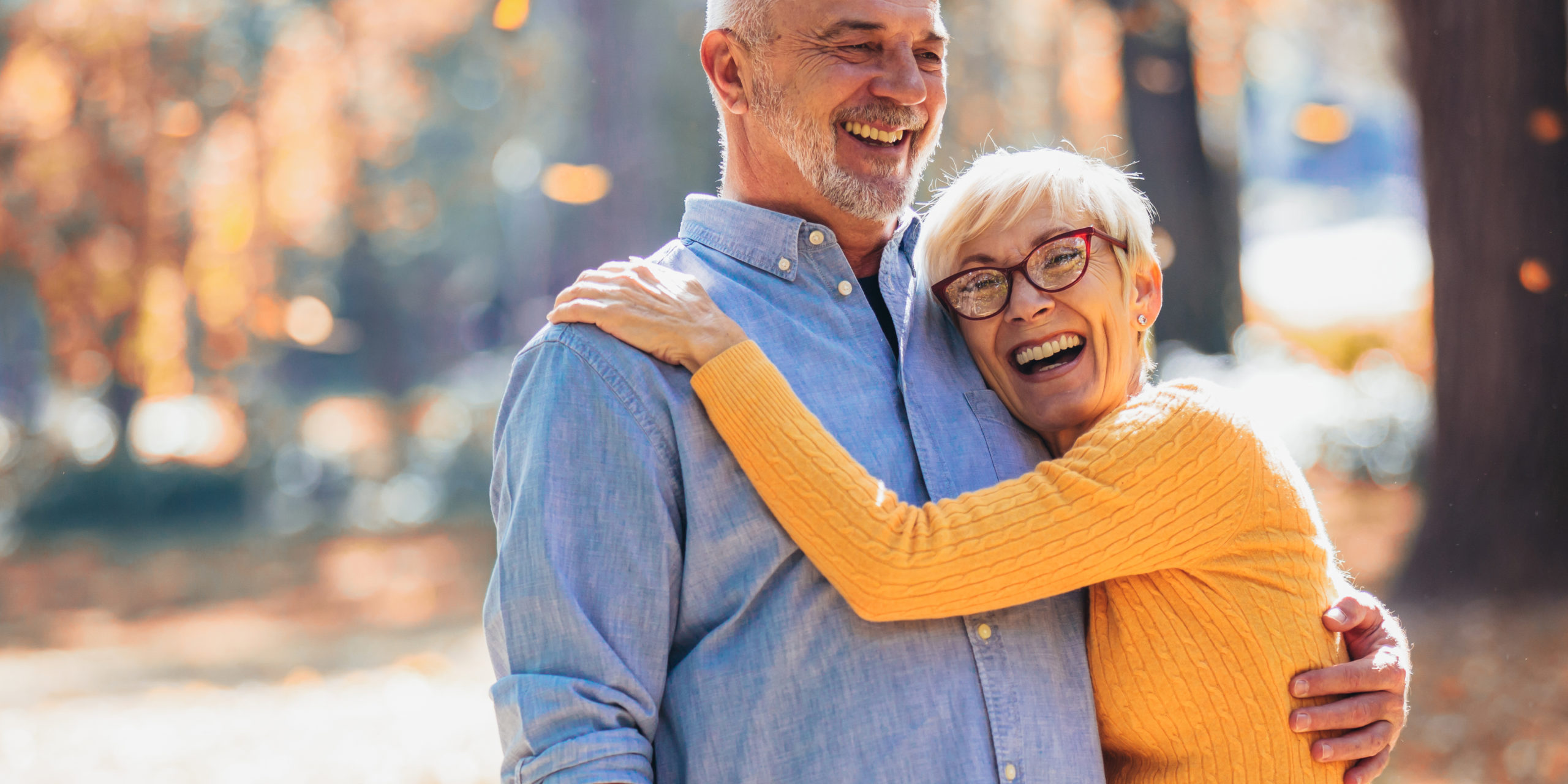Active seniors on a walk in autumn forest