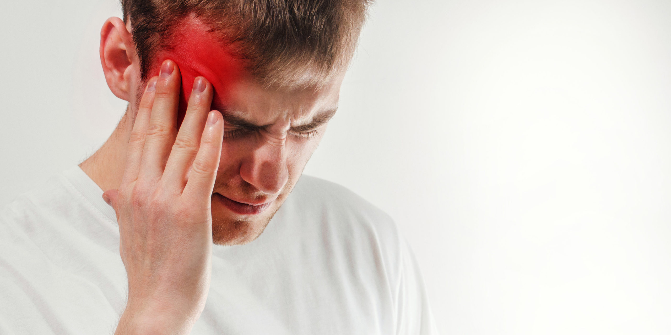 man hold his had and suffering from headache, pain, migraine, sad depressed isolated on white background, in a t shirt