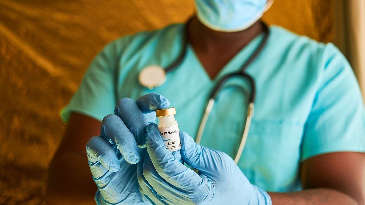 An,African,Doctor,Holding,A,Covid,19,Vaccine,Vial,In