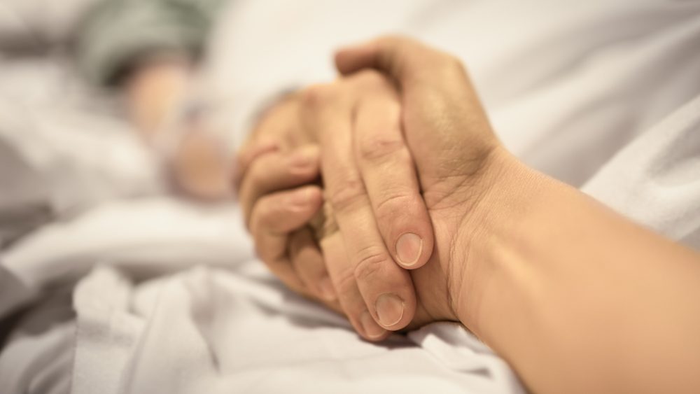 Man,Holding,Hand,,Giving,Support,And,Comfort,To,Woman,,Loved