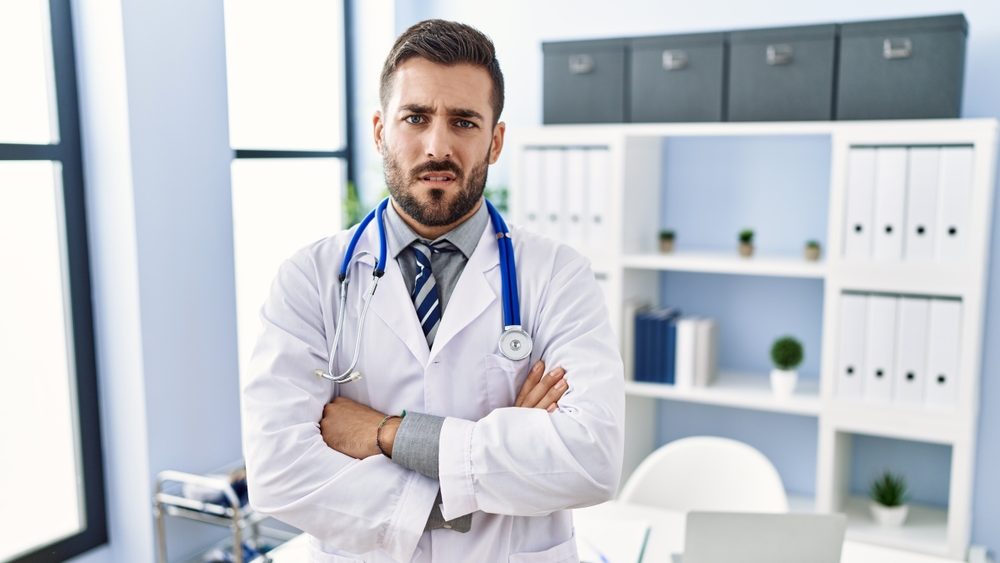 Handsome,Hispanic,Man,Wearing,Doctor,Uniform,And,Stethoscope,At,Medical