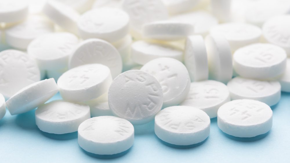 White,Aspirin,Pills,On,Blue,Paper,Background.,Pile,Of,Aspirin