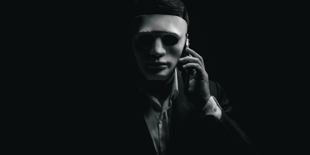 Unknown,Businessman,Wearing,Mask,With,Covered,Face,Using,Mobile,Phone