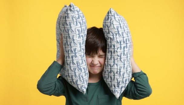 Boy blocking his ears with pillow - eight out of 10 GPs feel the govt's not listening