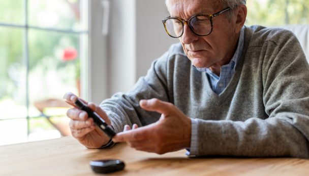 Man checking blood glucose levels