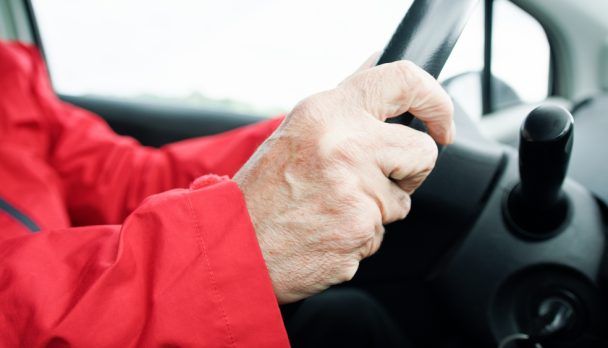 Hands,Of,An,Old,Driver,On,A,Steering,Wheel,Details