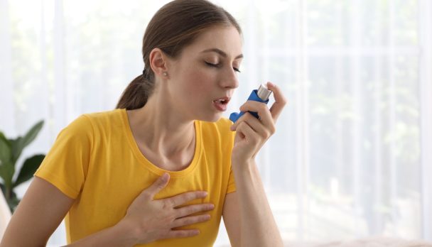 Young,Woman,Using,Asthma,Inhaler,At,Home.,Space,For,Text