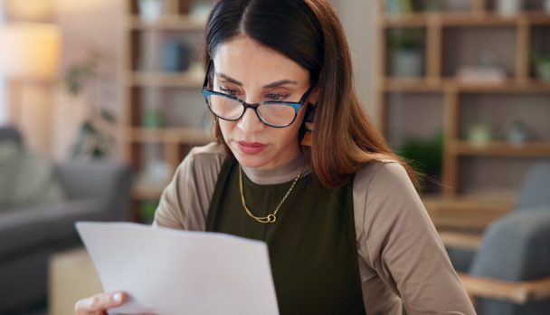 Thinking,,Woman,And,Reading,With,Paperwork,In,Home,Loan,Payment,